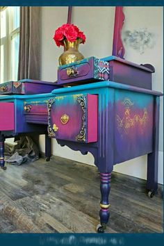 a purple and blue desk with flowers on top