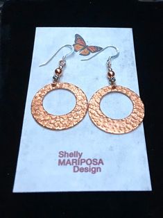 Lightweight Hammered copper hoop dangle earrings. Looking for something lightweight, bright and natural? This simple yet elegant pair of hammered copper earrings will definitely catch the light! These earrings are solid high-quality copper. One side is hammered, the other side of smooth. These earrings are 1 inch in diameter. They are very light weight, only 2 g. French ear wires are also solid copper. All my jewelry comes gift boxed with a custom Shelly Mariposa Design butterfly card ready for Hand Forged Copper Hoop Earrings With Dangle, Hand Forged Copper Dangle Hoop Earrings, Copper Drop Hoop Earrings As Gift, Handmade Small Hoop Copper Earrings, Hammered Copper Round Hoop Earrings, Copper Dangle Hoop Earrings Gift, Hammered Copper Hoop Jewelry, Handmade Small Copper Hoop Earrings, Small Copper Hoop Jewelry, Hammered