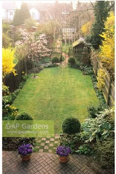 a garden with lots of green grass and flowers