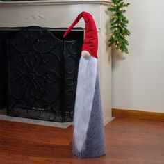 an elf standing in front of a fireplace