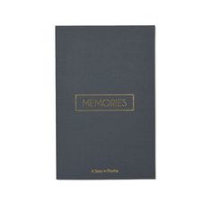 a gray book with gold lettering that reads memories