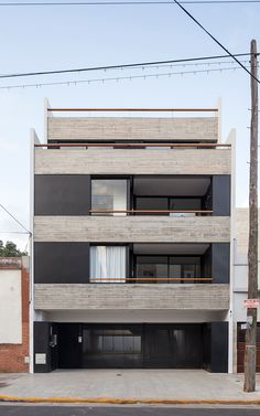 an apartment building with two balconies on the second floor