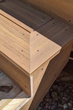 a close up of a wooden bench with wood slats on the ground next to it