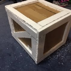 a cardboard box sitting on top of a floor