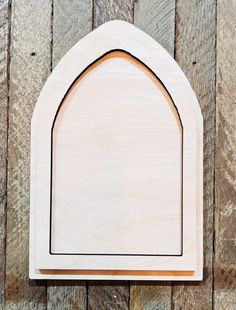 an unfinished wooden arch on a wood background with space for text or image to be put in