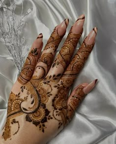 a woman's hand with henna on it