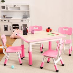 a child's table and chairs in a playroom with toys on the floor