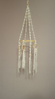 a white and gold chandelier hanging from the ceiling with tassels on it