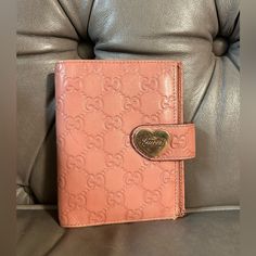 Gucci Pink Agenda Planner Mini Binder Passport Card Holder Guccisima Gg Mono Fits A Us Passport. Has A Pen Holder And 5 Credit Card Slots With A 6-Ring Binder And Slit Pockets On Both Sides. Snap Works Great With A Gold-Tone Gucci Heart Buckle. Serial Number Intact. Measures Approximately 5.5” X 4.25” X 1” In Preloved Condition With Rubbing, Scratches On Hardware And Corner Wear. Please See All Pictures And Zoom In For Details. Us Passport, Snap Words, Passport Card, Gucci Pink, Mini Binder, Agenda Planner, Bags Gucci, Card Holder Wallet, Ring Binder