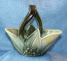 a ceramic bowl with an artistic design on the bottom and two leaves in the middle