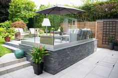 an outdoor patio with chairs, table and umbrella