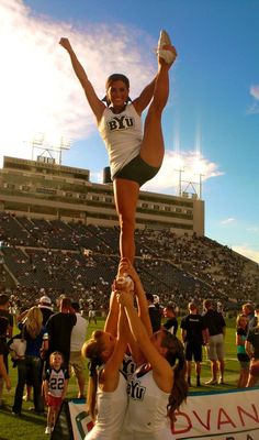 the cheerleaders are doing tricks for the crowd