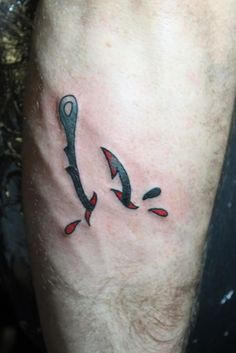 a man with a knife tattoo on his leg