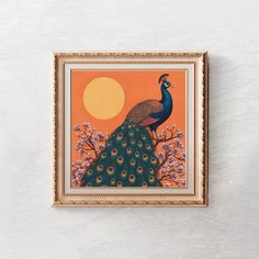 a peacock is sitting on top of a flowered tree in front of an orange sky