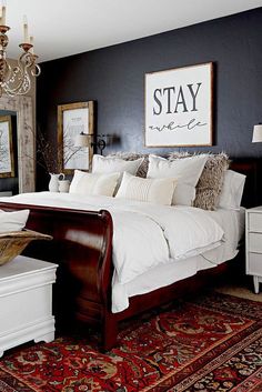 a bedroom with a large bed and chandelier hanging from the ceiling above it