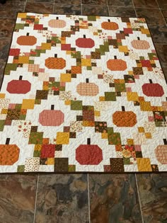 a quilted table runner with pumpkins on it