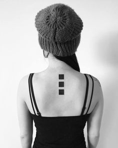 a woman with a cross tattoo on her back