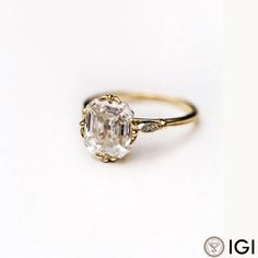 an engagement ring with a large diamond in the center on a white background, close up