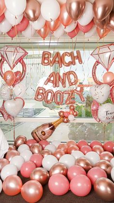 balloons and confetti are on display in front of a window with the words beach and booze