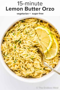 a white bowl filled with rice and lemon wedges