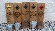 three wooden signs with metal buckets and one has a man cave sign on it