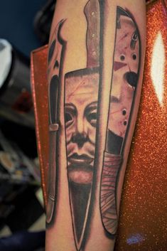 a man's arm with two knives and a face on the inside of it