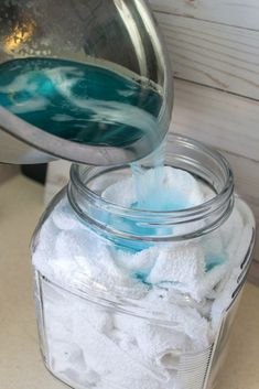 a glass jar filled with blue and white powder