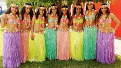 a group of women in colorful hula skirts standing next to each other