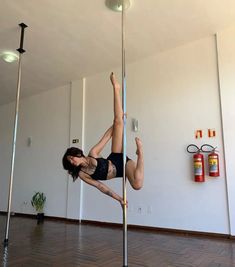 a woman is doing pole dancing on the floor