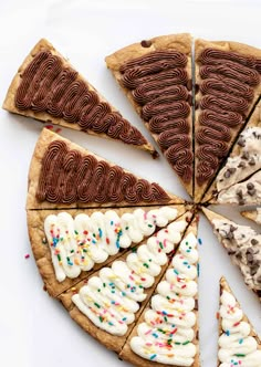 several slices of chocolate chip pizza with white frosting and sprinkles