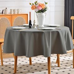 a dining room table with two place settings