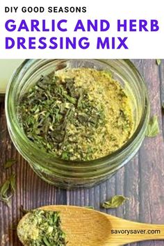 garlic and herb dressing mix in a glass jar with wooden spoons next to it