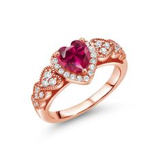 a rose gold ring with an oval shaped ruby and white diamonds on the band, set in