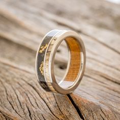 a wedding ring with wood and gold inlays