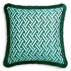 a green pillow with an intricate design on it