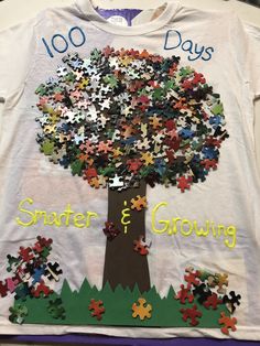 a t - shirt with puzzle pieces on it that says 100 days smarter and growing