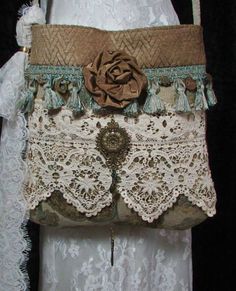 the purse is made from lace and has a flower on it's side,