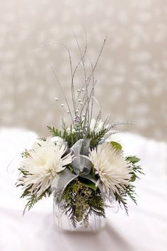 a vase filled with white flowers on top of a table