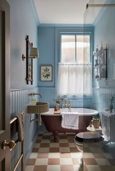 a bathroom with a checkered floor and blue walls