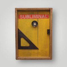 a wooden box with a red and black sign on it that says subliminal