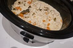 a crock pot filled with rice and carrots