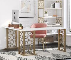 a white desk with gold accents and pink chairs