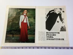 an old fashion magazine is opened to show a woman in a red dress and white shirt