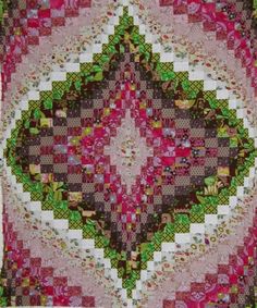 a pink, green and white quilt with an intricate design on the center piece is shown