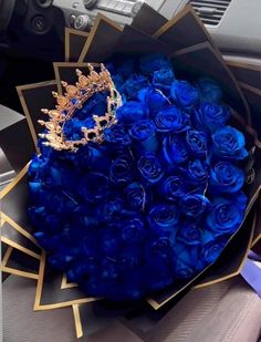 a bouquet of blue roses and a tiara in a car's dashboard area