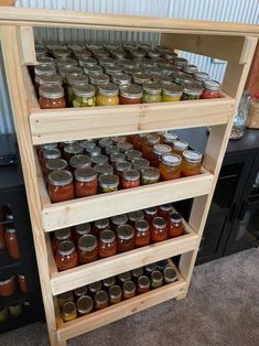 several shelves filled with jars on top of each other