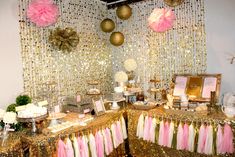 a table topped with lots of cake and desserts covered in gold sequins