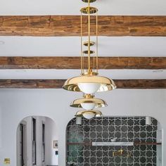 a chandelier hanging from the ceiling in a room with black and white tiles