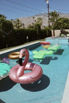 an inflatable flamingo float sitting on the edge of a swimming pool