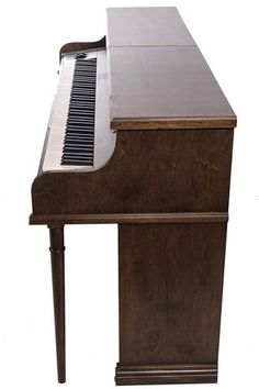 an old piano is sitting upright on a white background